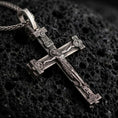 Load image into Gallery viewer, Sterling silver Orthodox cross pendant necklace with an oxidized finish resting on textured volcanic rock, captured in a close-up premium studio composition.
