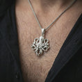 Load image into Gallery viewer, Polished silver octopus pendant necklace worn on the neck, shown against the chest in a clean and striking everyday wear composition.
