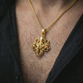 Load image into Gallery viewer, Gold plated octopus pendant necklace worn on the neck, captured on a human model in a premium dark-toned lifestyle frame.
