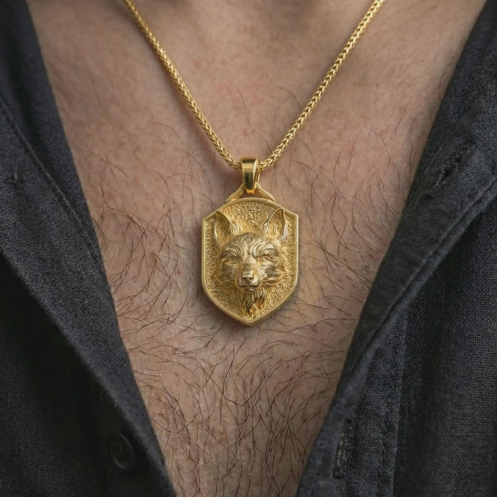 Gold plated fox shield pendant necklace worn on the neck, captured on a human model in a premium dark-toned lifestyle frame.