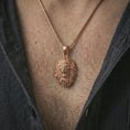 Load image into Gallery viewer, Rose gold plated roaring lion head pendant necklace worn on the neck, presented in a close-up lifestyle shot with a refined wildlife-inspired aesthetic.
