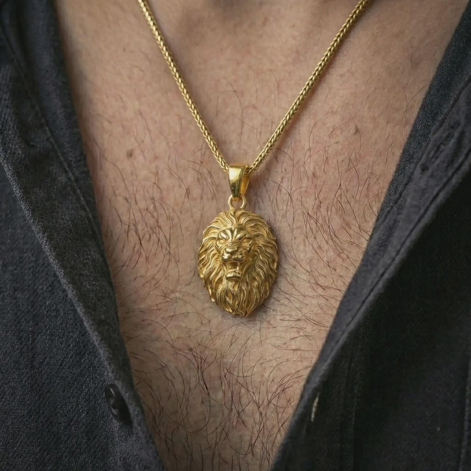 Gold plated roaring lion head pendant necklace worn on the neck, captured on a human model in a premium dark-toned lifestyle frame.