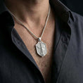 Load image into Gallery viewer, Polished silver Saint Michael shield pendant necklace worn on the neck, shown against the chest in a clean and elegant everyday wear composition.

