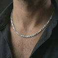 Load image into Gallery viewer, Polished silver DNA helix chain necklace worn on the neck, shown against the chest in a clean and distinctive everyday wear composition.
