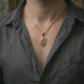 Load image into Gallery viewer, Rose gold plated roaring lion shield pendant necklace worn on the neck, presented in a close-up lifestyle shot with a refined warrior-inspired aesthetic.
