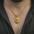 Load image into Gallery viewer, Gold plated crowned lion head pendant necklace worn on the neck, captured on a human model in a premium dark-toned lifestyle frame.
