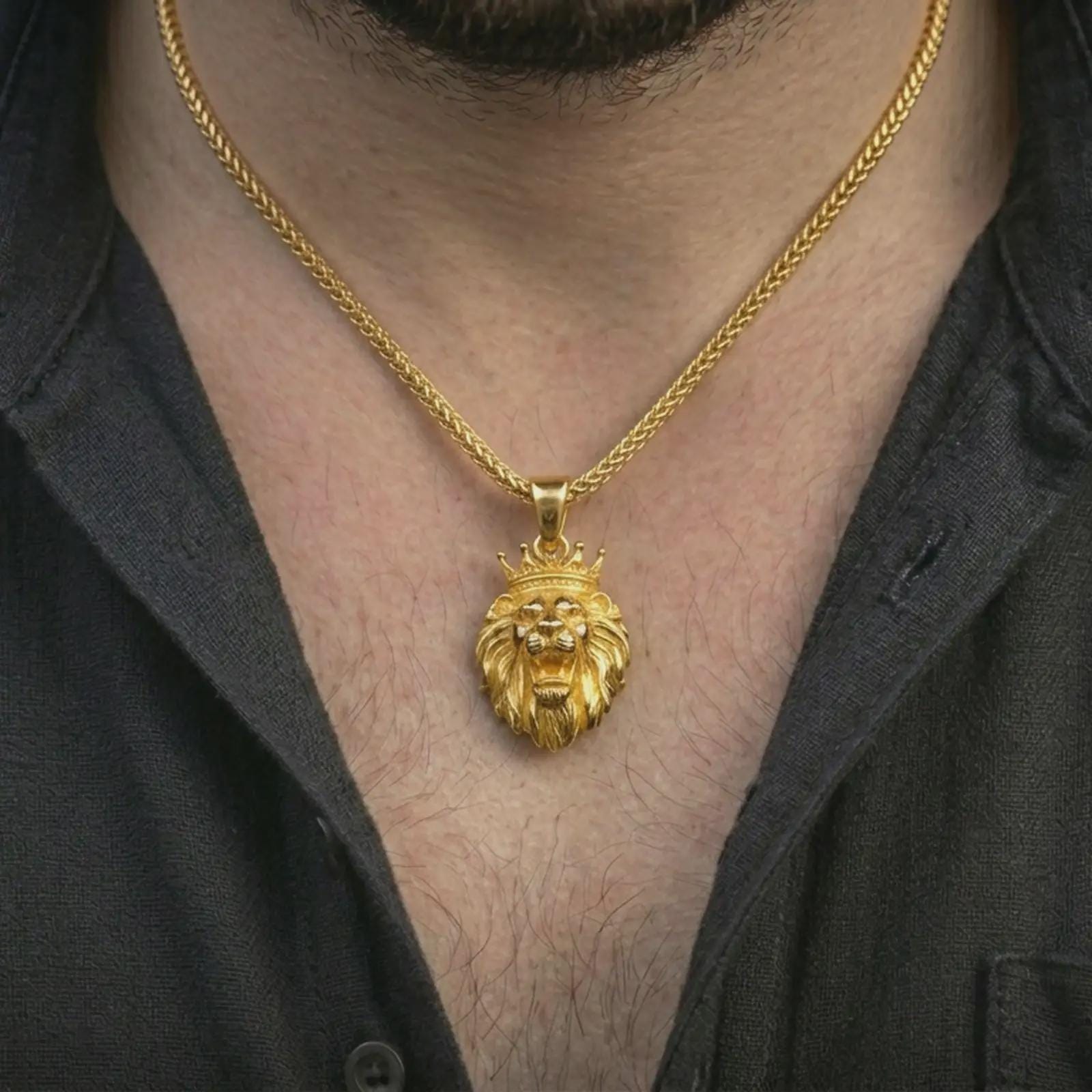 Gold plated crowned lion head pendant necklace worn on the neck, captured on a human model in a premium dark-toned lifestyle frame.