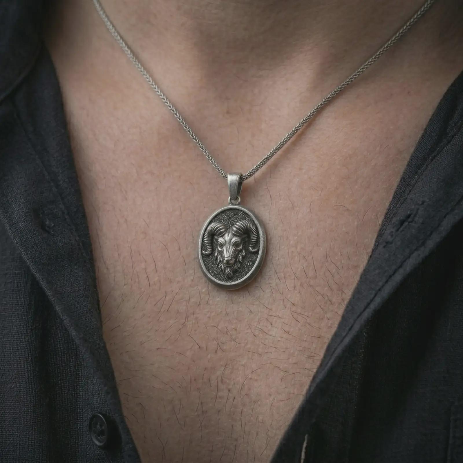 Oxidized ram head pendant necklace worn on the neck, styled in a dark lifestyle portrait with an open shirt and strong symbolic presentation.