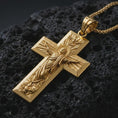 Load image into Gallery viewer, Gold plated Jesus Ascension cross pendant necklace presented on porous volcanic rock, highlighting the devotional cross form in a luxurious close-up jewelry image.
