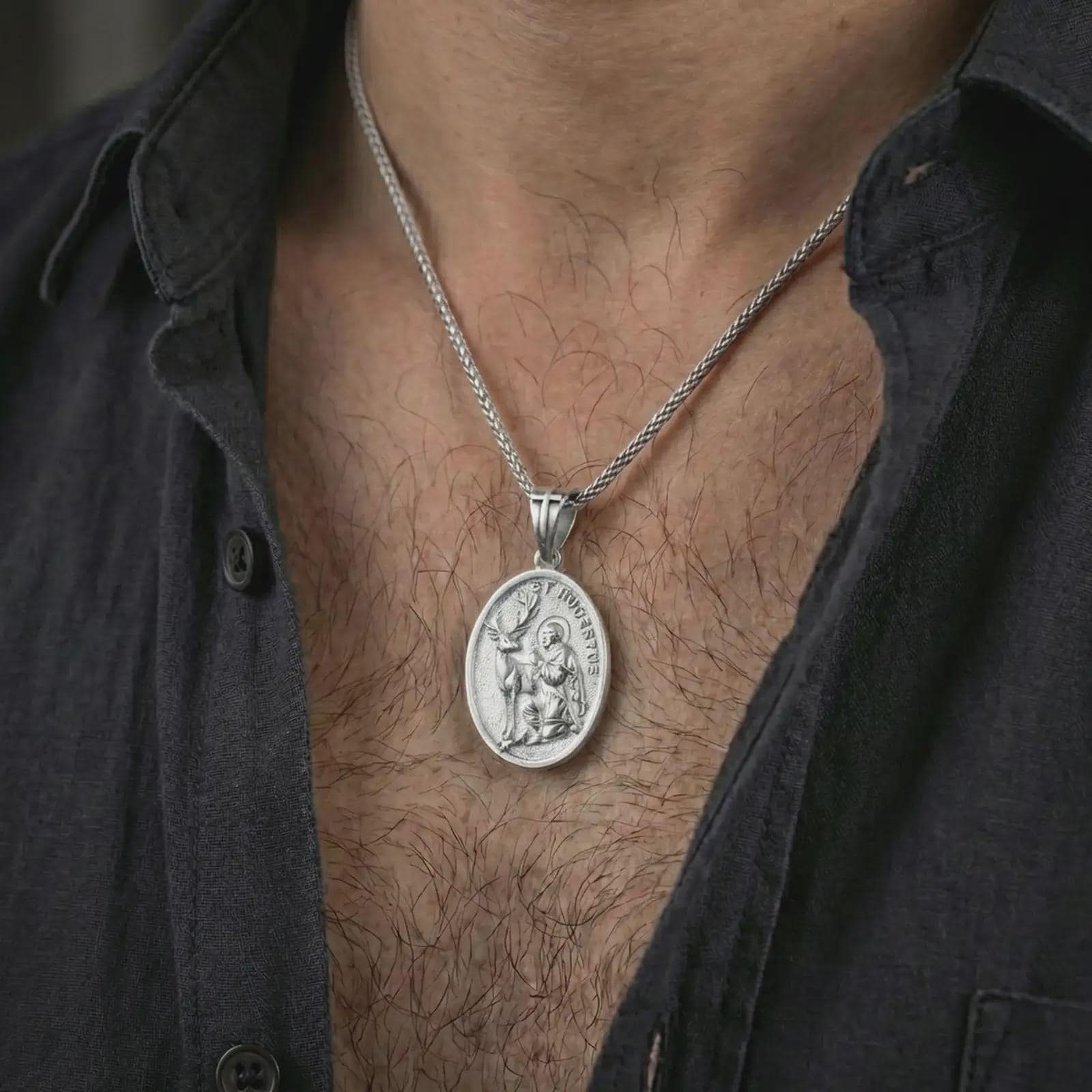 Polished silver Saint Hubert pendant necklace worn on the neck, shown against the chest in a clean and elegant everyday wear composition.