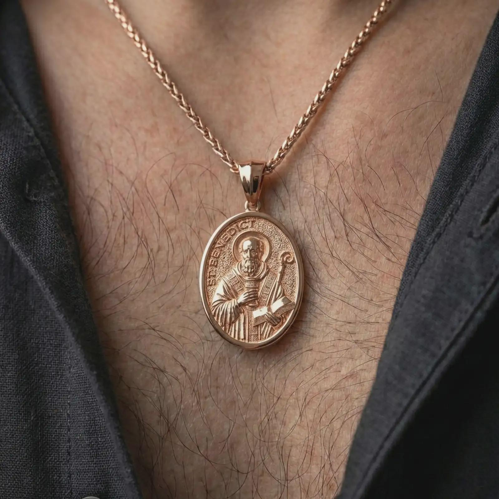 Rose gold plated Saint Benedict pendant necklace worn on the neck, presented in a close-up lifestyle shot with a refined masculine aesthetic.