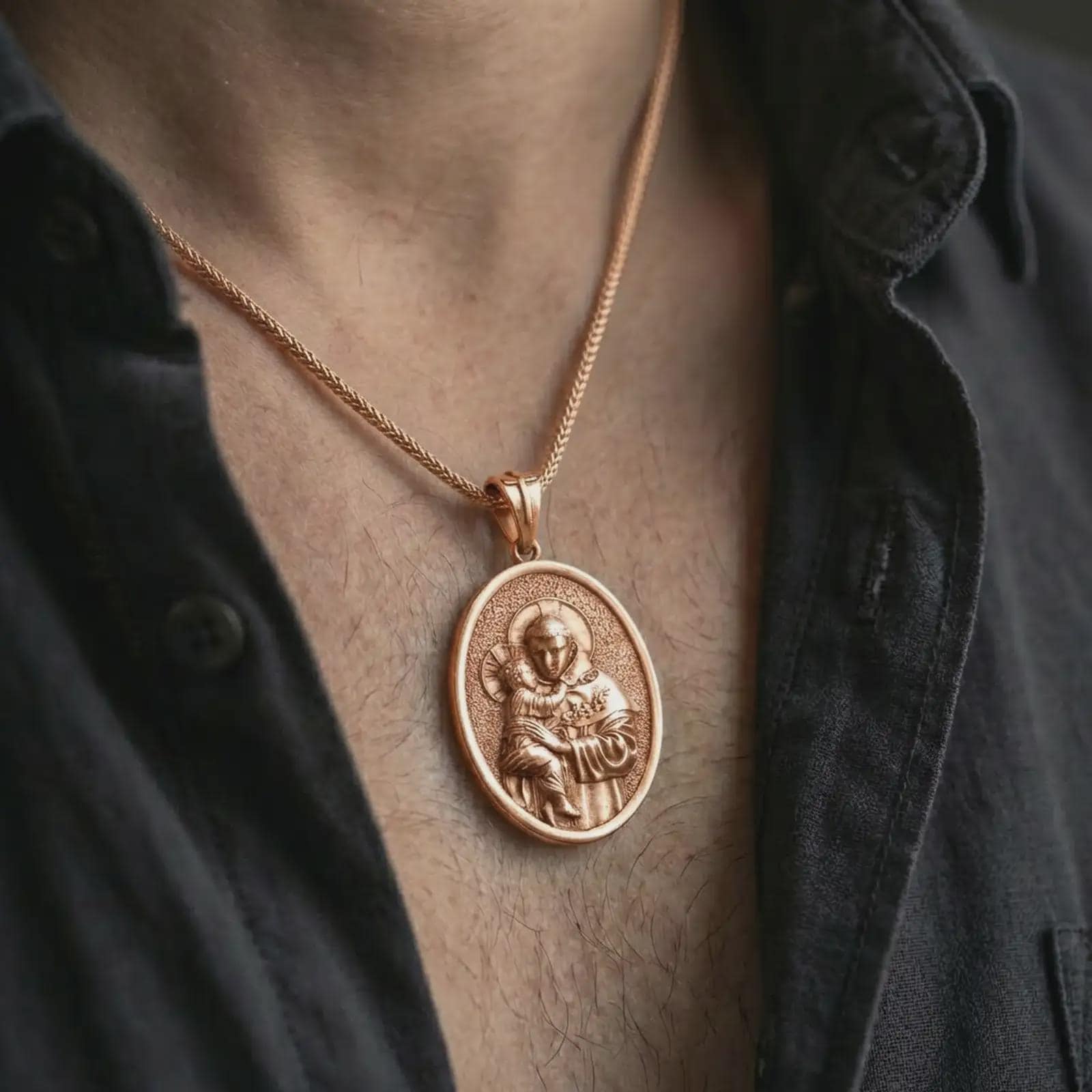 Rose gold plated Saint Anthony pendant necklace worn on the neck, presented in a close-up lifestyle shot with a refined masculine aesthetic.