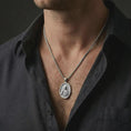 Load image into Gallery viewer, Polished silver Jesus Christ pendant necklace worn on the neck, shown against the chest in a clean and elegant everyday wear composition.
