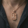 Load image into Gallery viewer, Rose gold plated Saint Patrick dog tag pendant necklace worn on the neck, presented in a close-up lifestyle shot with a refined masculine aesthetic.
