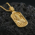 Load image into Gallery viewer, Gold plated Saint Patrick dog tag pendant necklace presented on porous volcanic rock, highlighting the rectangular devotional form in a luxurious close-up jewelry image.
