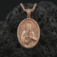 Load image into Gallery viewer, Rose gold plated Saint Peter pendant necklace on dark volcanic rock, photographed in a detailed premium studio macro view.
