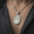 Load image into Gallery viewer, Polished silver Saint Michael Archangel pendant necklace worn on the neck, shown against the chest in a clean and elegant everyday wear composition.
