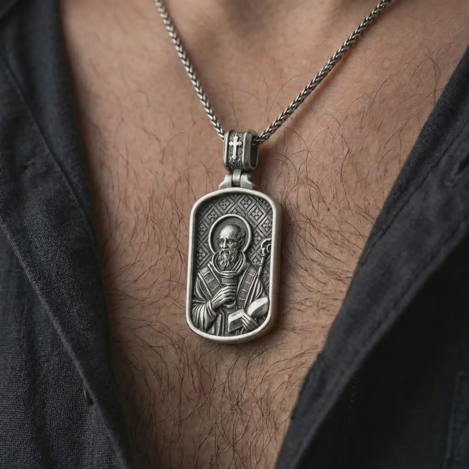 Oxidized Saint Benedict dog tag pendant necklace worn on the neck, styled in a dark lifestyle portrait with an open shirt and masculine presentation.