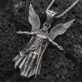 Load image into Gallery viewer, Sterling silver Archangel Michael pendant necklace with an oxidized finish resting on textured volcanic rock, captured in a close-up premium studio composition.
