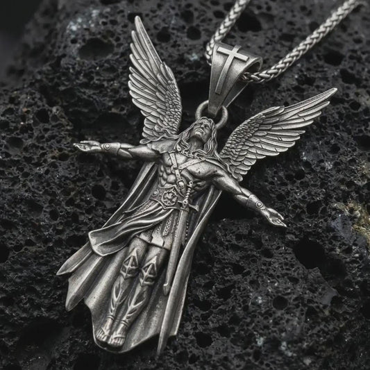 Sterling silver Archangel Michael pendant necklace with an oxidized finish resting on textured volcanic rock, captured in a close-up premium studio composition.