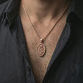 Load image into Gallery viewer, Rose gold plated Saint Rita pendant necklace worn on the neck, presented in a close-up lifestyle shot with a refined masculine aesthetic.
