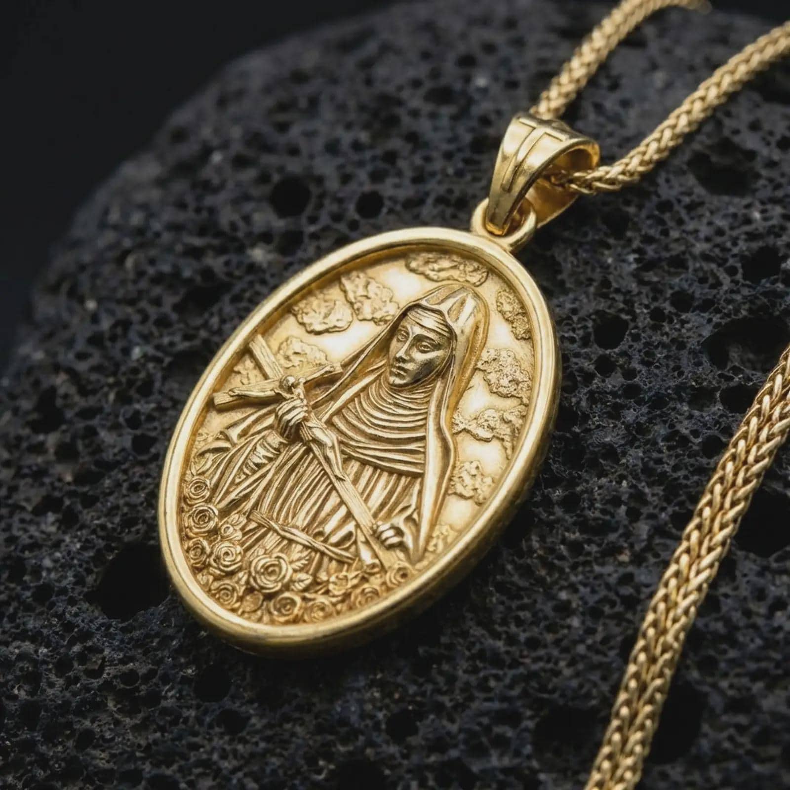 Gold plated Saint Rita pendant necklace presented on porous volcanic rock, highlighting the oval medallion form and sacred devotional design in a luxurious close-up jewelry image.