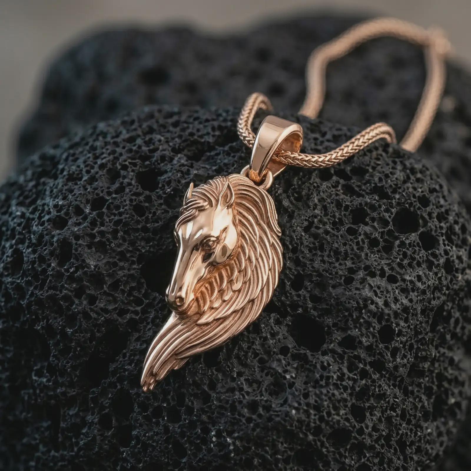 Rose gold plated Pegasus wing horse pendant necklace on dark volcanic rock, photographed in a detailed premium studio macro view.