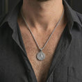 Load image into Gallery viewer, Polished silver Saint Benedict medal pendant necklace worn on the neck, shown against the chest in a clean and elegant everyday wear composition.
