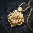 Load image into Gallery viewer, Gold plated chessboard pendant necklace presented on porous volcanic rock, highlighting the tactical game-inspired design in a luxurious close-up jewelry image.

