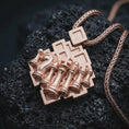 Load image into Gallery viewer, Rose gold plated chessboard pendant necklace on dark volcanic rock, photographed in a detailed premium studio macro view.
