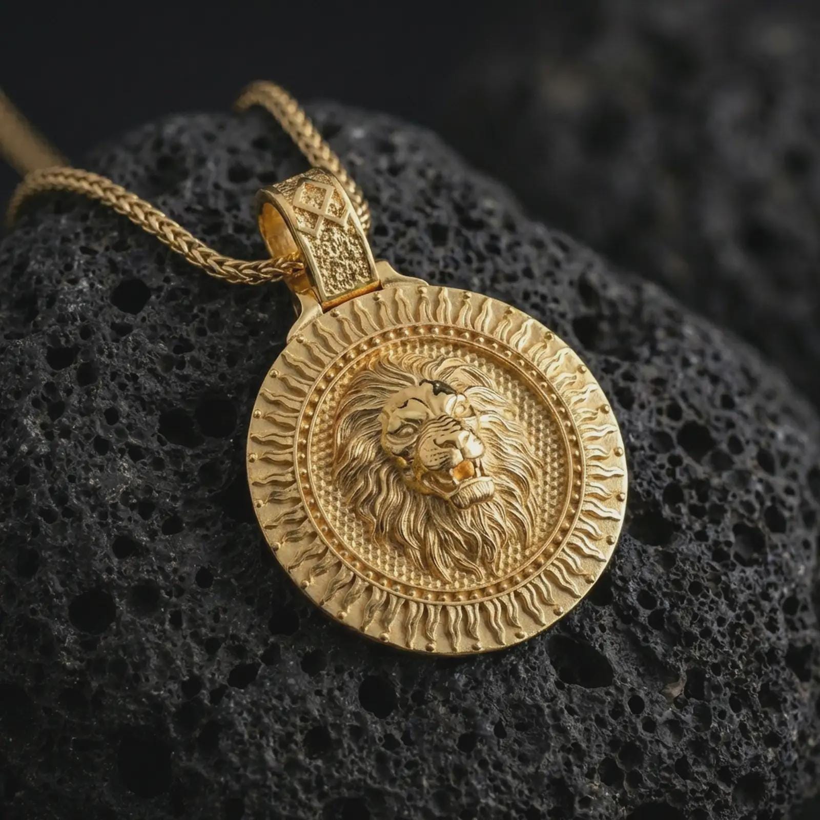 Gold plated Viking lion medallion pendant necklace presented on porous volcanic rock, highlighting the Norse-inspired lion guardian motif in a luxurious close-up jewelry image.