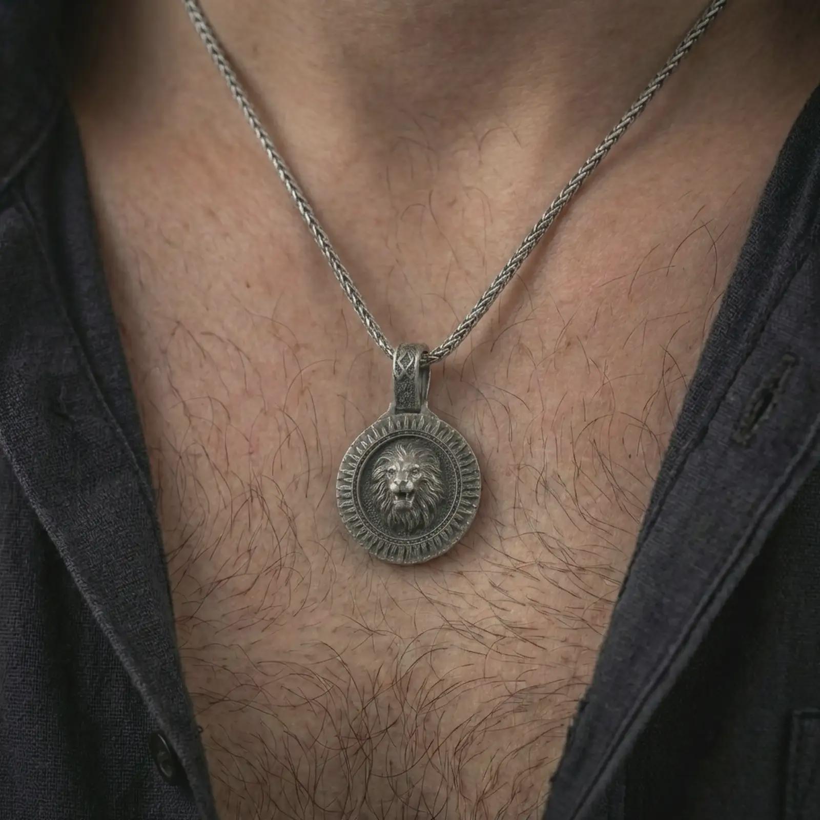 Oxidized Viking lion medallion pendant necklace worn on the neck, styled in a dark lifestyle portrait with an open shirt and bold warrior-inspired presentation.