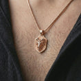 Load image into Gallery viewer, Rose gold plated ram head shield pendant necklace worn on the neck, presented in a close-up lifestyle shot with a refined zodiac aesthetic.
