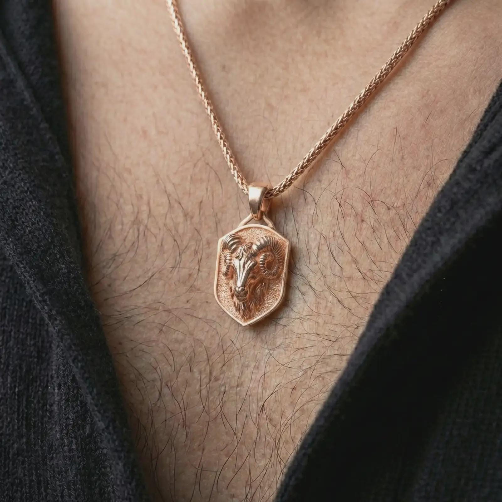 Rose gold plated ram head shield pendant necklace worn on the neck, presented in a close-up lifestyle shot with a refined zodiac aesthetic.