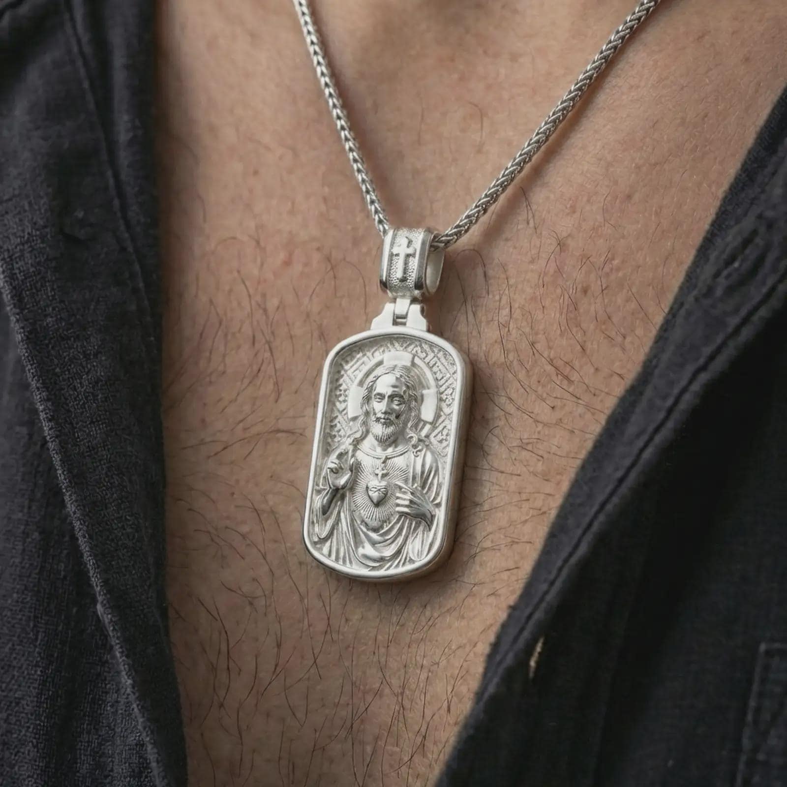 Polished silver Sacred Heart pendant necklace worn on the neck, shown against the chest in a clean and elegant everyday wear composition.