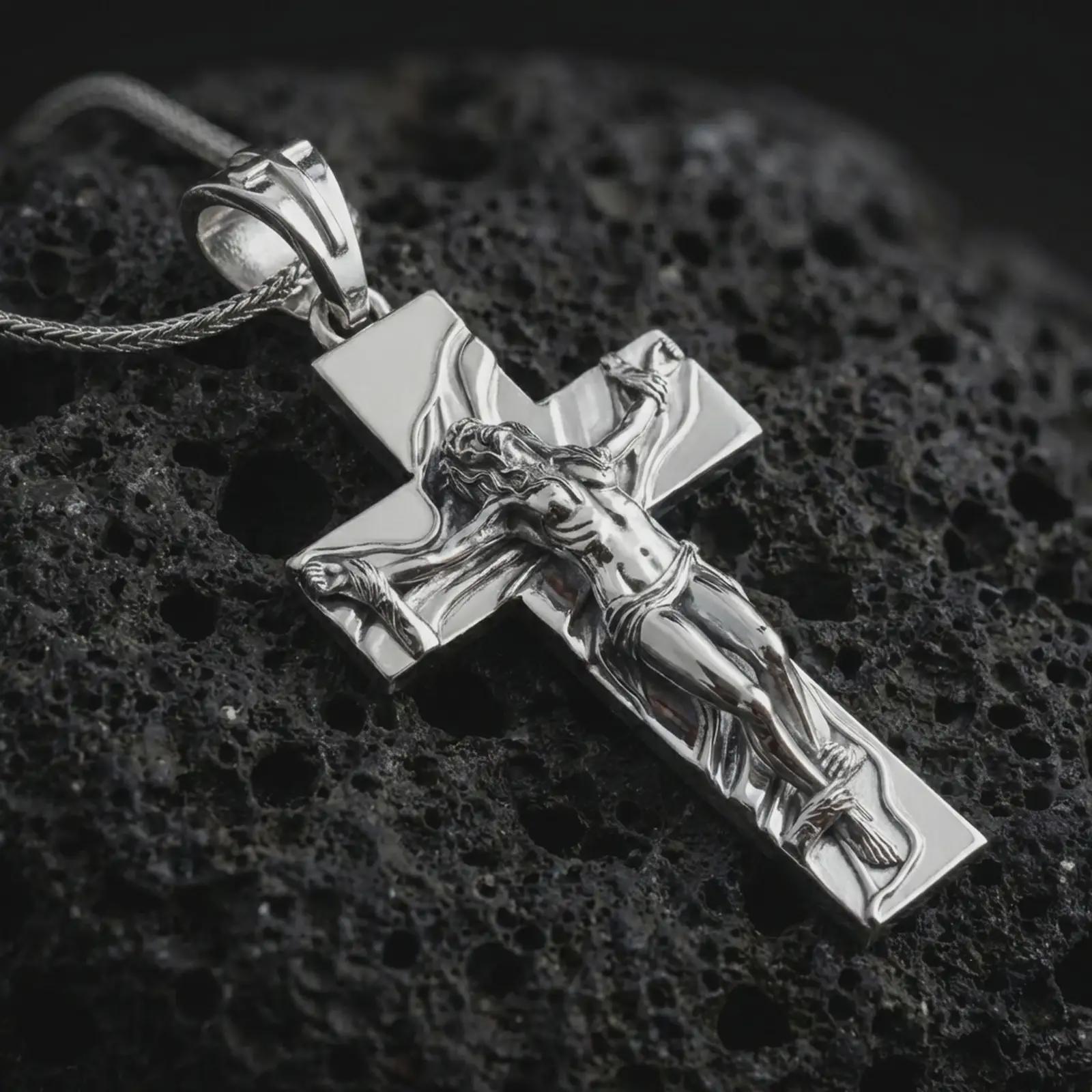 Polished silver symbolic cross pendant displayed on black volcanic rock, shown in a refined macro product shot with sculpted female figure and cross relief.
