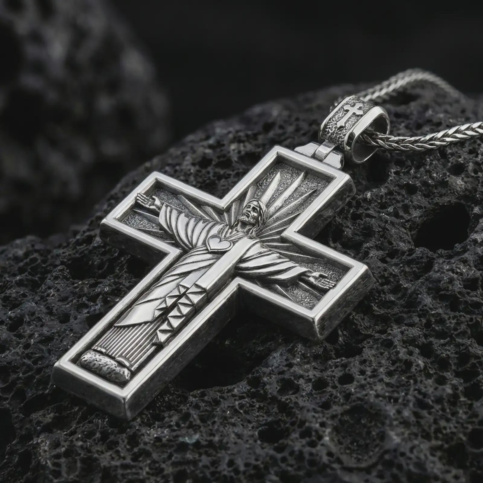 Polished silver Cristo Protetor cross pendant necklace displayed on black volcanic rock, shown in a refined macro product shot with detailed sacred figure and radiant cross relief.