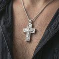 Load image into Gallery viewer, Polished silver Cristo Protetor cross pendant necklace worn on the neck, shown against the chest in a clean and elegant everyday wear composition.
