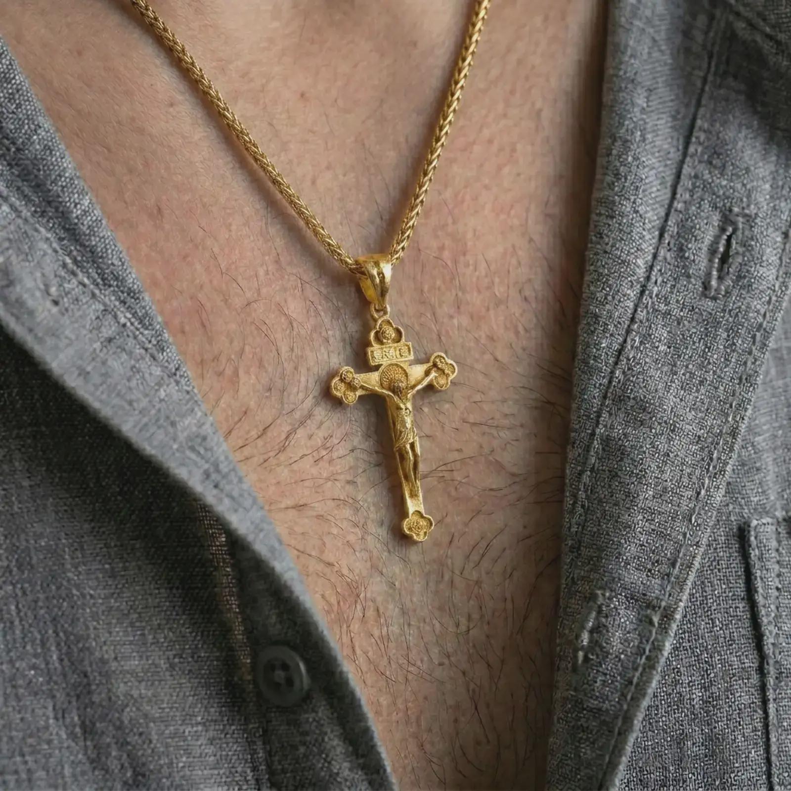 Gold plated crucifix pendant necklace worn on the neck, captured in a premium lifestyle composition with the cross pendant centered as a strong spiritual statement.