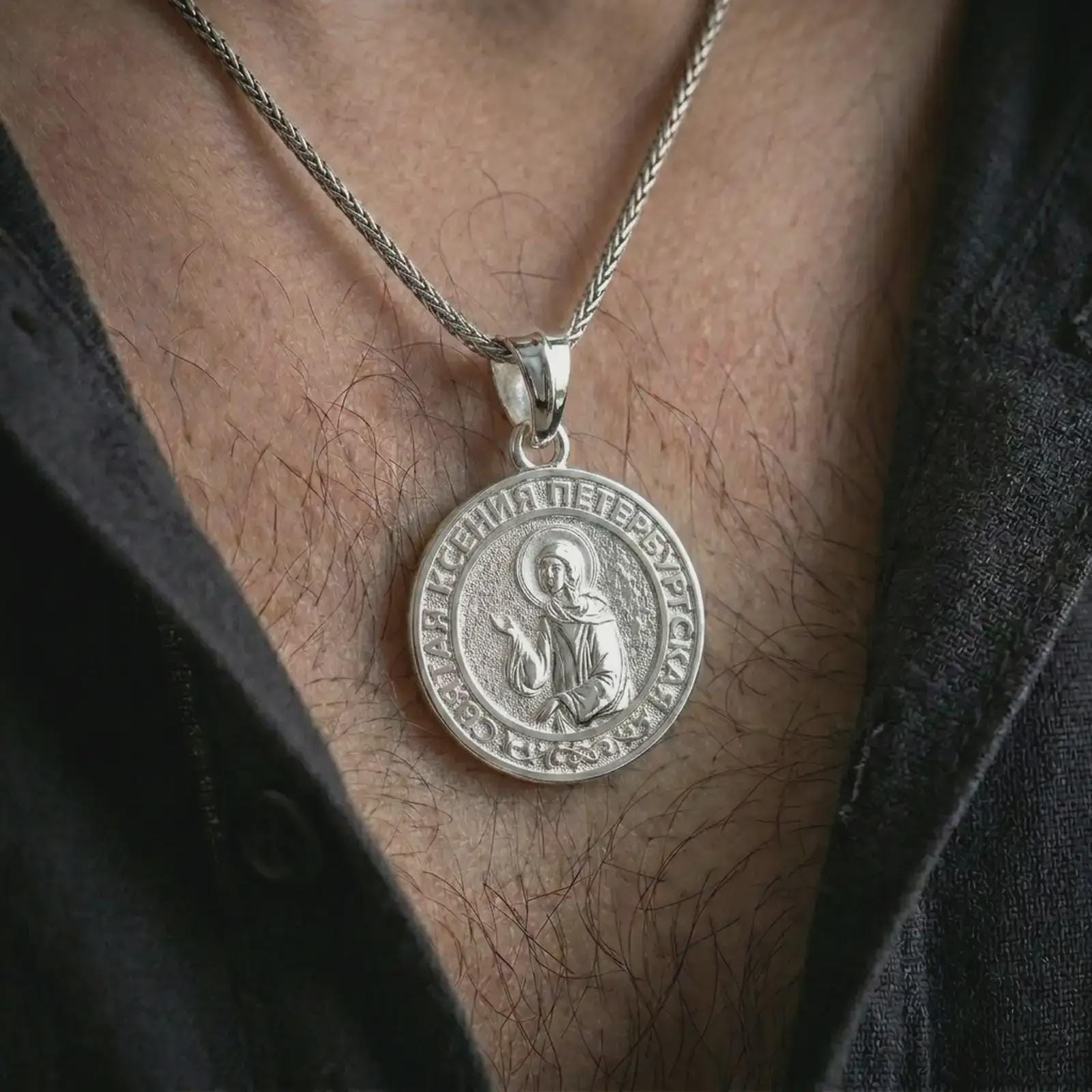 Polished silver Saint Xenia pendant necklace worn on the neck, presented in a clean model shot with a timeless Christian and Orthodox inspired appearance.