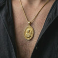 Load image into Gallery viewer, Gold plated Madonna and Child pendant necklace worn on the neck, captured in an elegant lifestyle composition that highlights the sacred mother and child image as a spiritual Christian statement piece.
