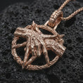 Load image into Gallery viewer, Rose gold plated bad dream catcher pendant necklace on dark volcanic rock, photographed in a detailed premium studio macro view.
