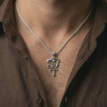 Load image into Gallery viewer, Polished silver Eye of Ra and Ankh pendant necklace worn on the neck, shown against the chest in a clean and elegant everyday wear composition.
