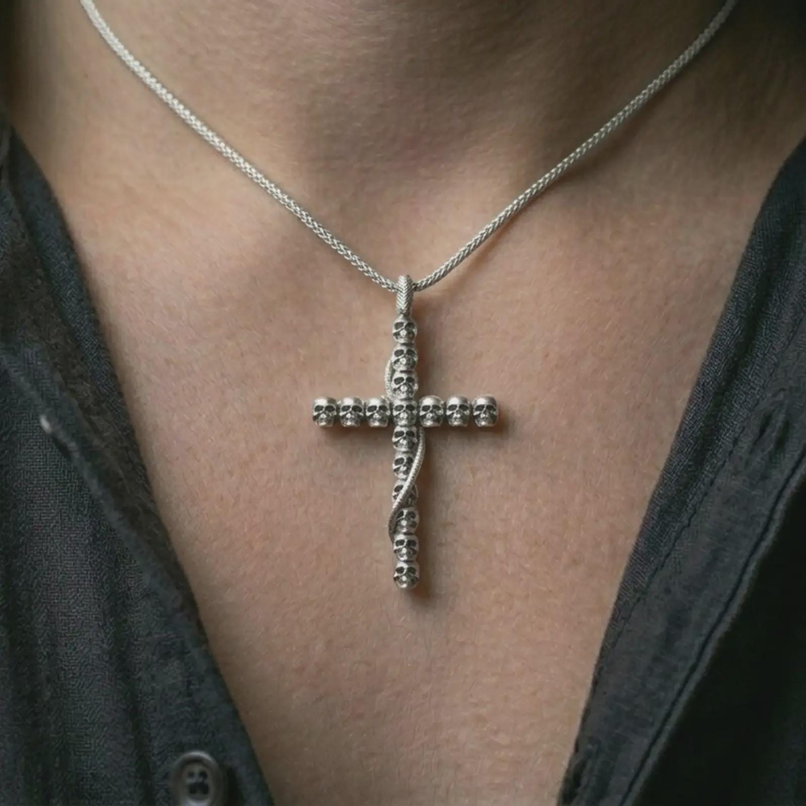 Polished silver skull cross pendant necklace worn on the neck, shown against the chest in a clean and edgy everyday wear composition.