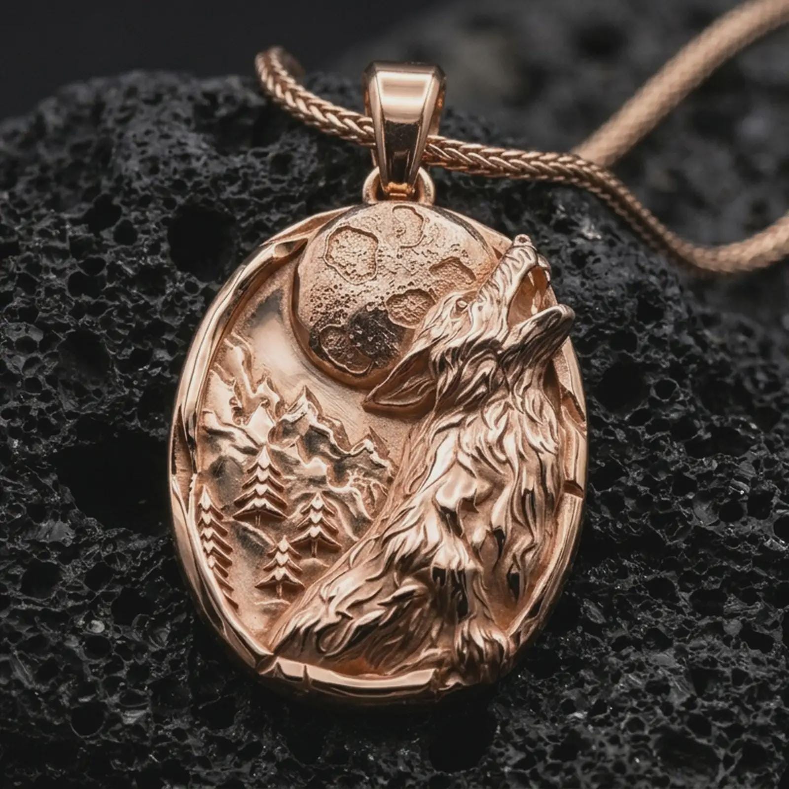 Rose gold plated howling wolf pendant necklace on dark volcanic rock, photographed in a detailed premium studio macro view.