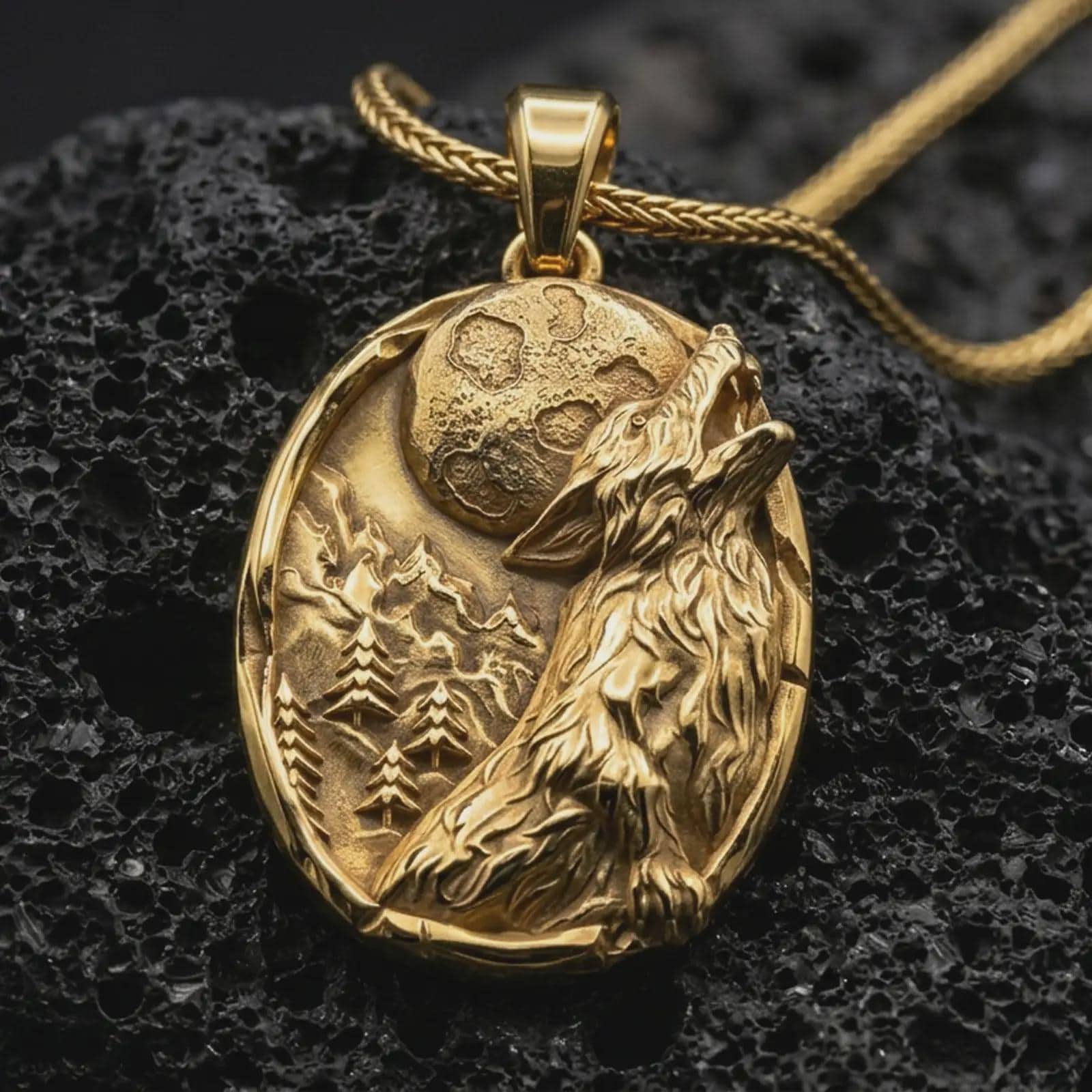 Gold plated howling wolf pendant necklace presented on porous volcanic rock, highlighting the oval wilderness design in a luxurious close-up jewelry image.