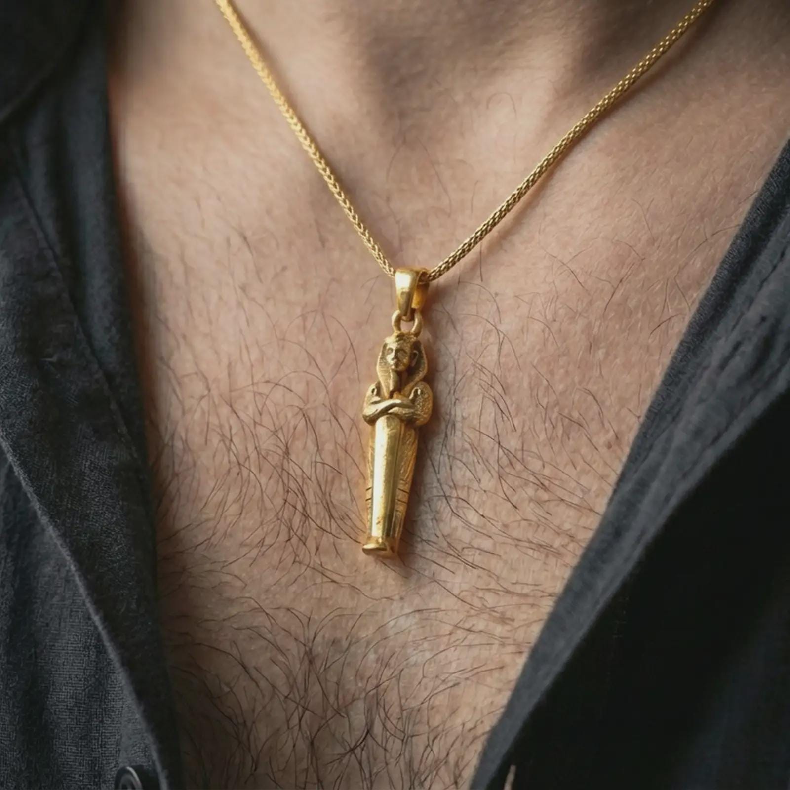 Gold plated King Tut pendant necklace worn on the neck, captured on a human model in a premium dark-toned lifestyle frame.