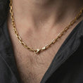 Load image into Gallery viewer, Gold plated cable link chain necklace worn on the neck, captured on a human model in a premium dark-toned lifestyle frame.
