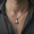 Load image into Gallery viewer, Polished silver origami airplane pendant necklace worn on the neck, shown against the chest in a clean and elegant everyday wear composition.

