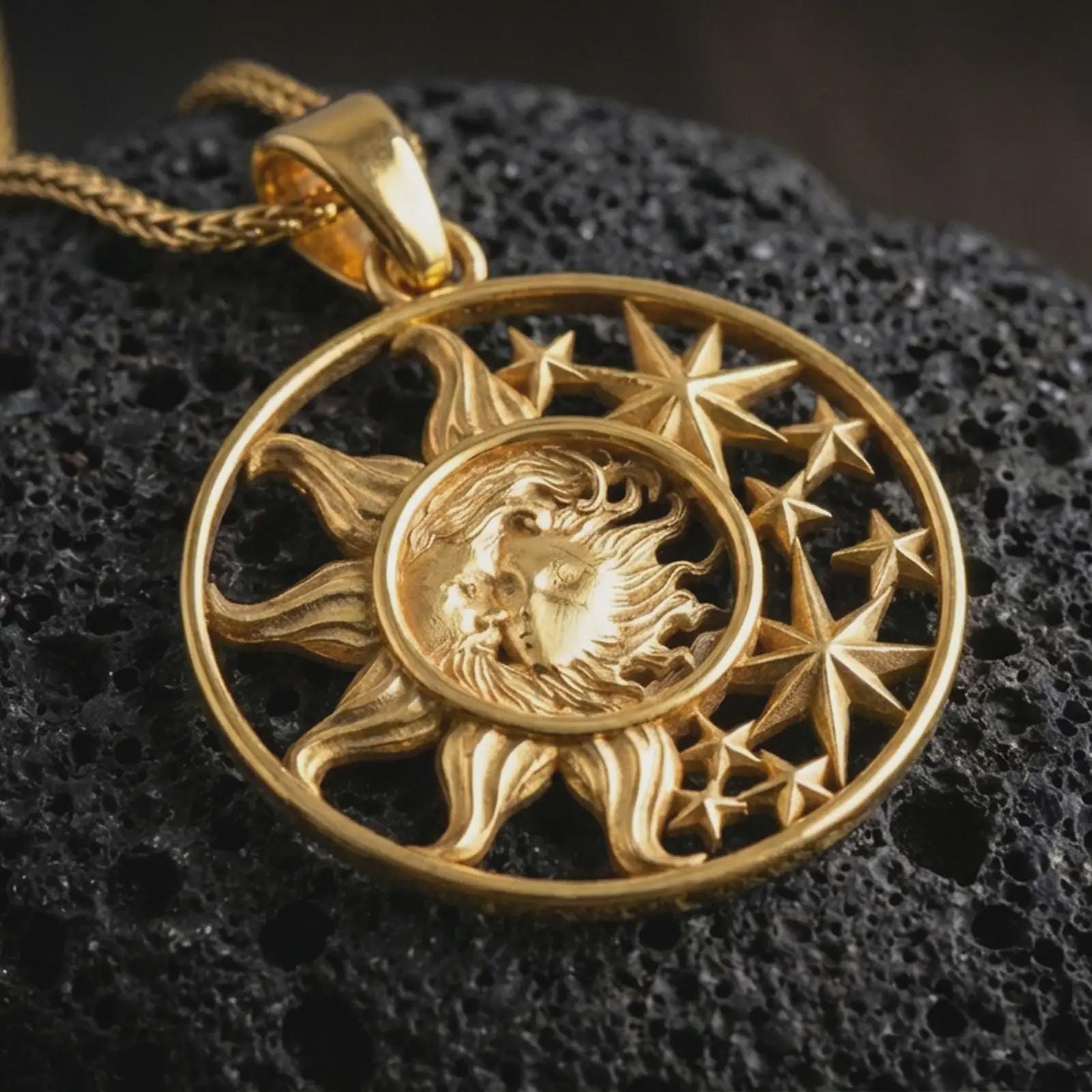 Gold plated sun and moon pendant necklace presented on porous volcanic rock, highlighting the circular cosmic design in a luxurious close-up jewelry image.